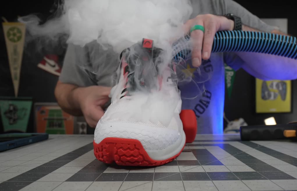 Head Motion Pro Pickleball Shoes undergoing a breathability test with a steam pipe to evaluate airflow and ventilation.